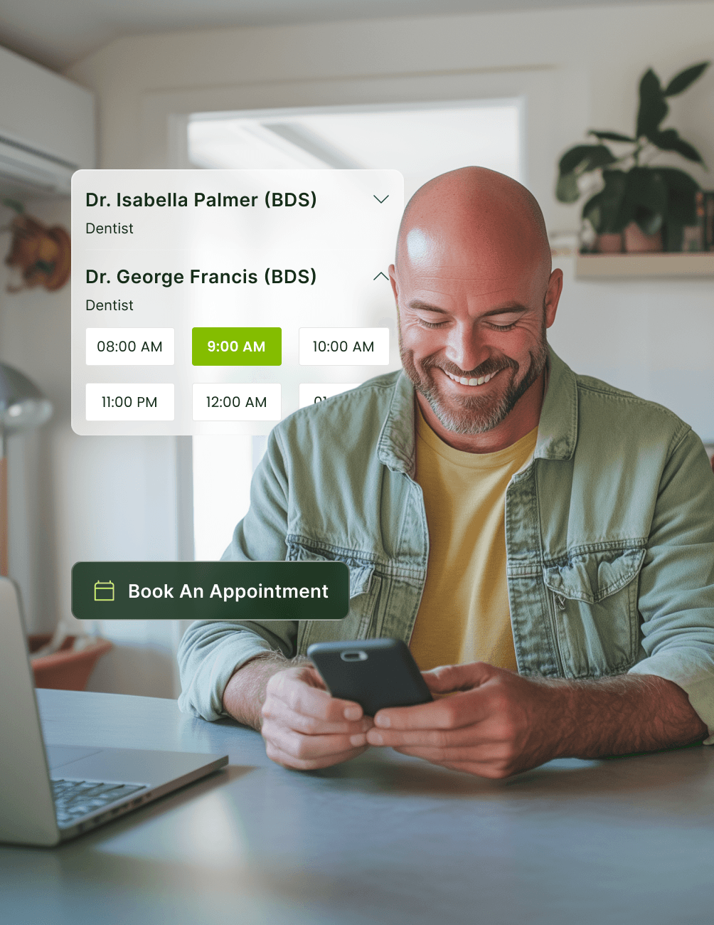 Man smiling at phone with dentist appointment times on screen, laptop nearby.