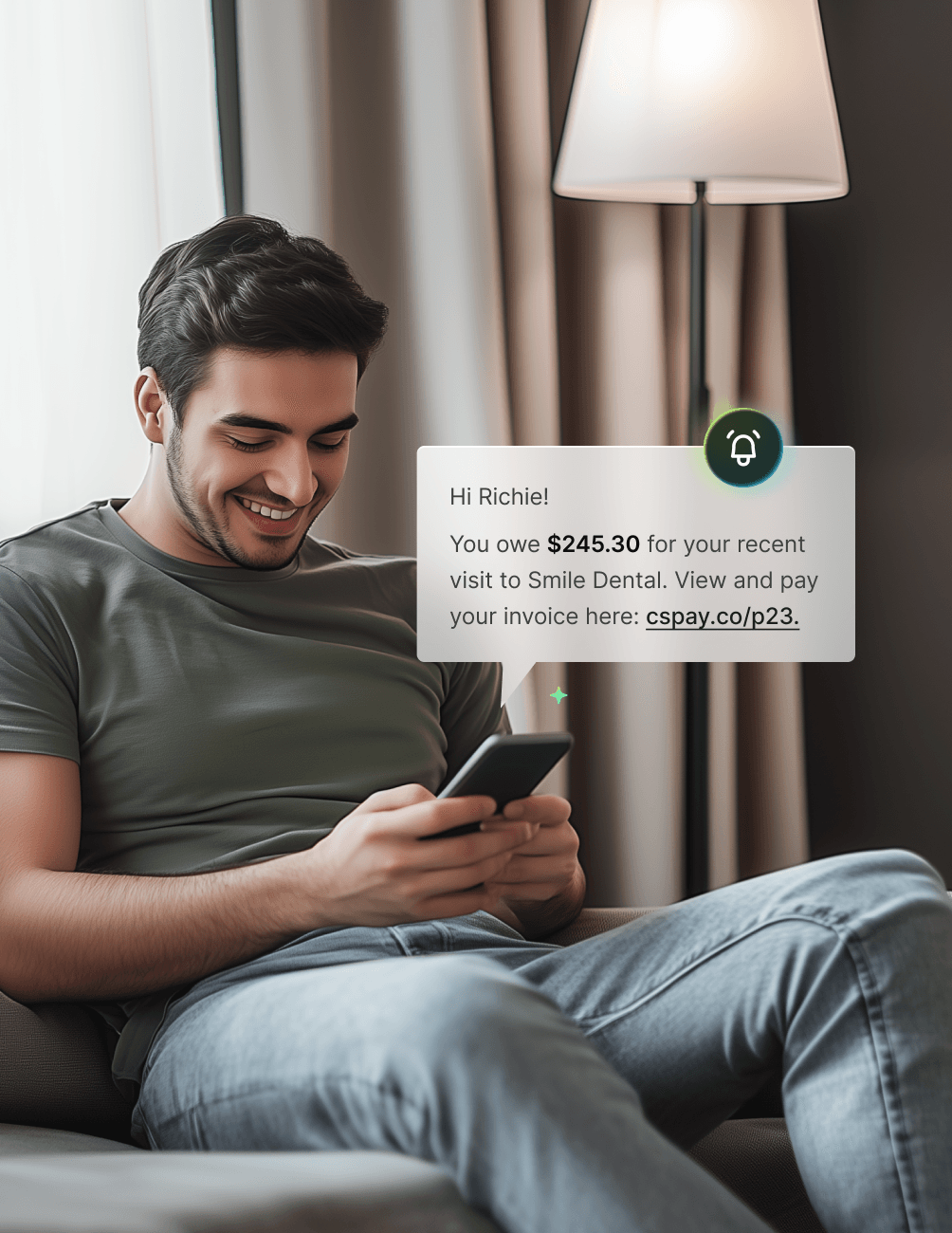A man sitting on a couch smiles while looking at his phone. A notification about a dental invoice payment is displayed beside him.