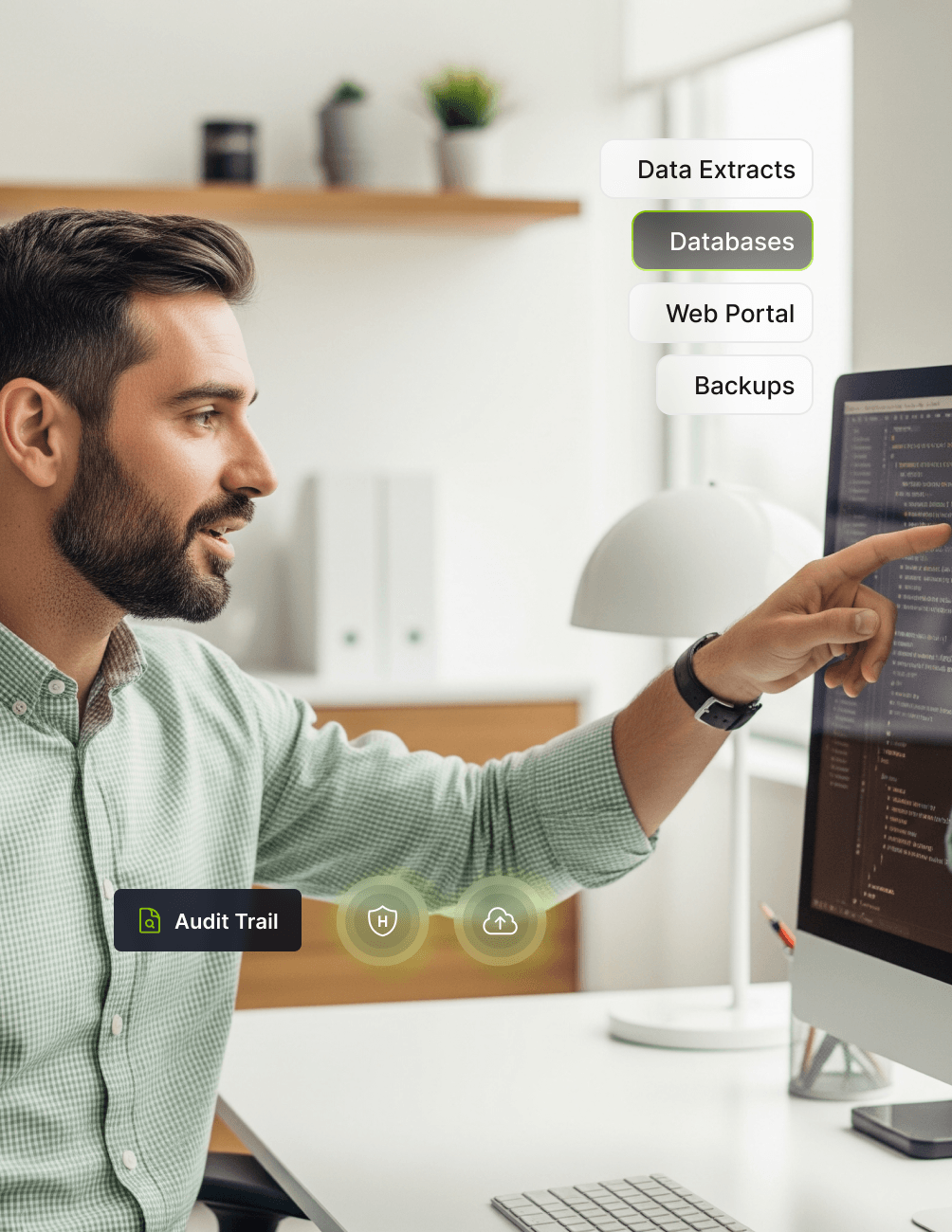 Man pointing at computer screen with code; icons labeled "Audit Trail," "Data Extracts," "Databases," "Web Portal," and "Backups" floating nearby.