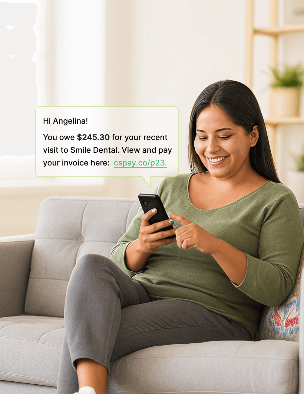 Smiling woman on a couch checks her phone, reading a message about a $245.30 dental bill with a link to view and pay the invoice.