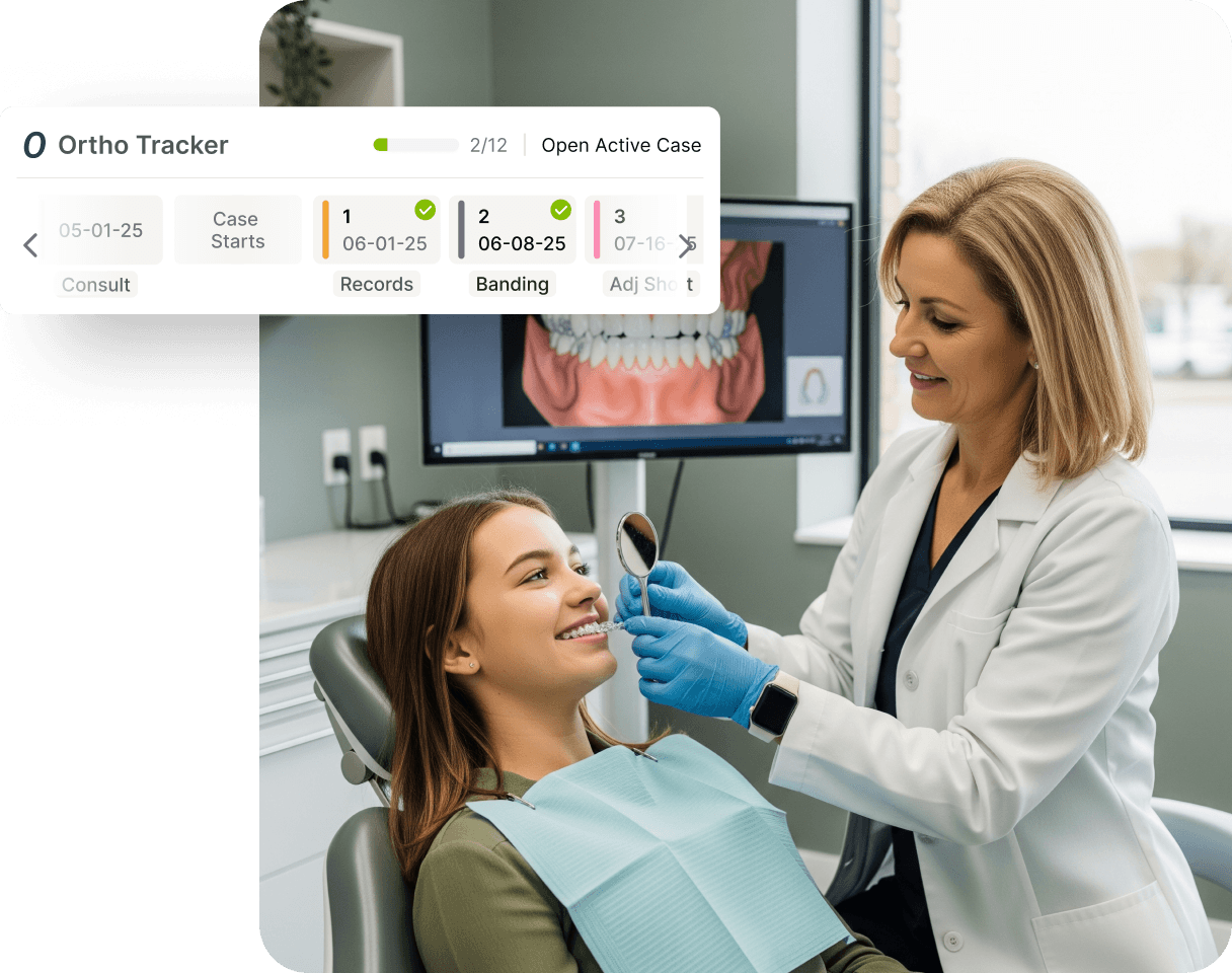 Dentist examining a smiling patient's teeth while using orthodontic tracking software on a screen in the dental office.