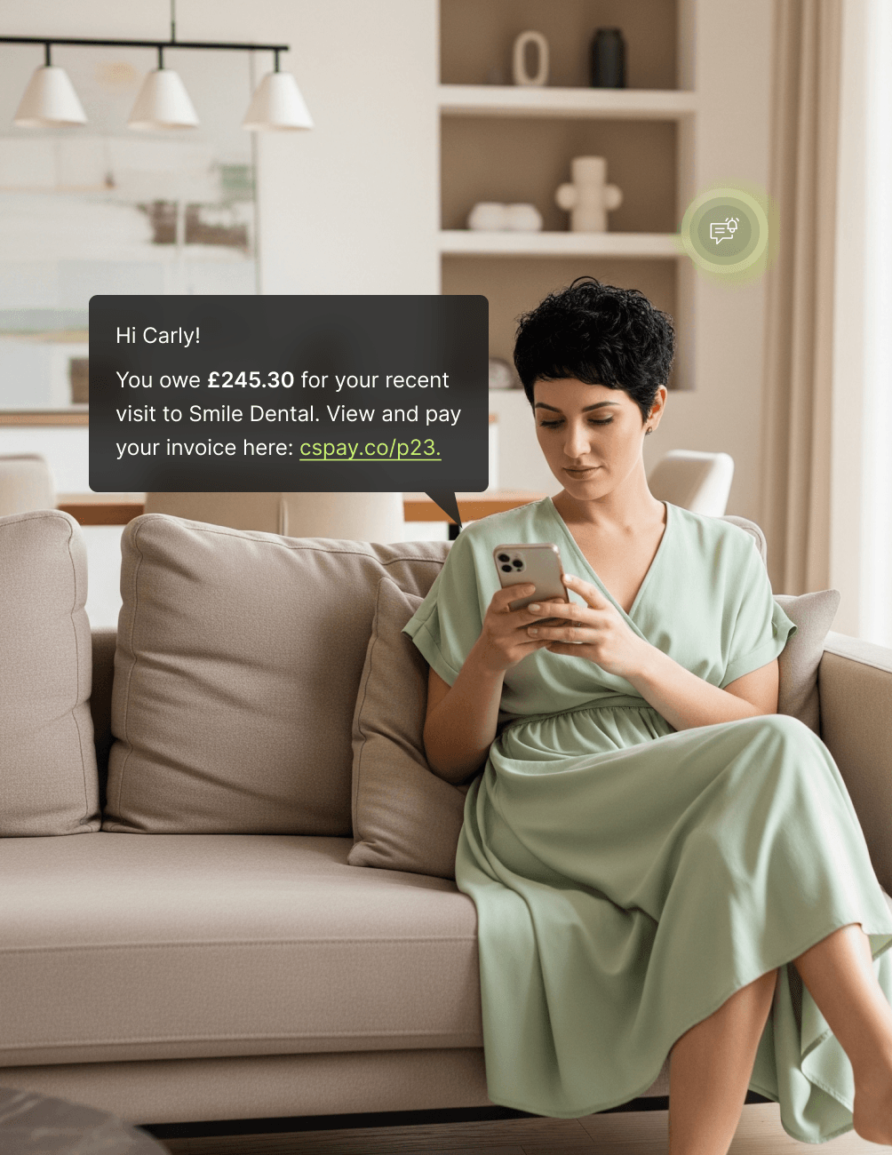 Individual Messages Woman in green dress sitting on a beige sofa, reading a dental payment message on her phone. Home interior in the background.
